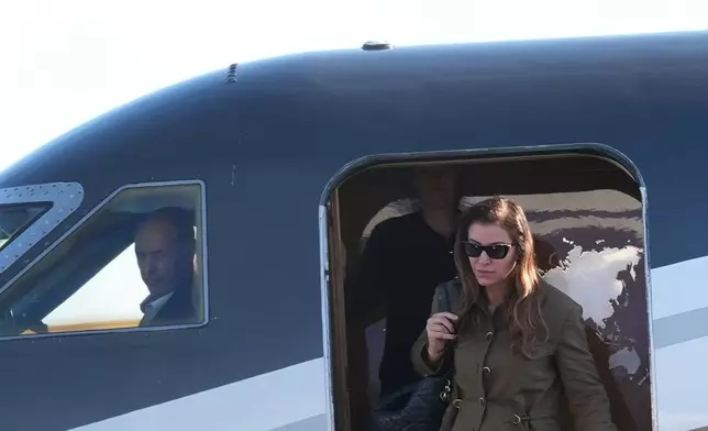 Fernanda Bolsonaro along with her husband, Flávio Bolsonaro arrive at Miami-Opa Locka Executive Airport on Wednesday, Oct. 28, 2026, in Opa-locka, Fla. (AP Photo/Marta Lavandier)