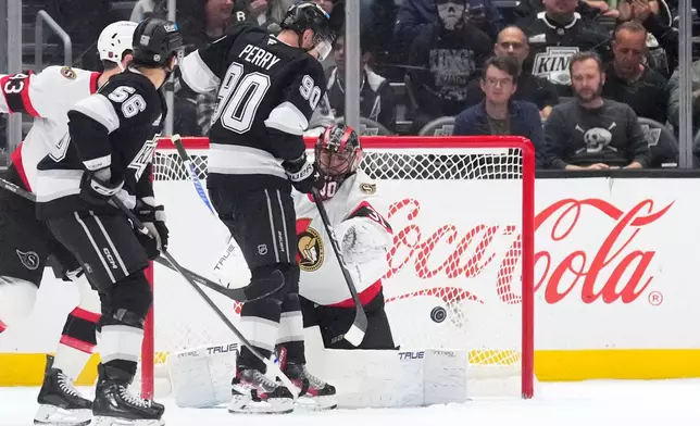Los Angeles Kings left wing Erik Haula, second from left, scores on Ottawa Senators goaltender Jonas Johansson, right, as right wing Corey Perry watches during the first period of an NHL hockey game Thursday, Oct. 29, 2026, in Los Angeles. (AP Photo/Mark J. Terrill)