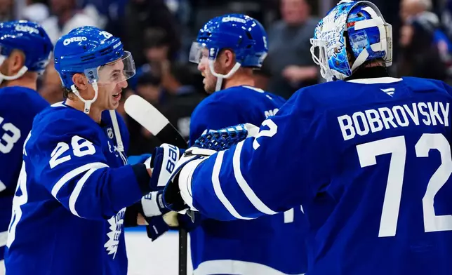 Toronto Maple Leafs' Troy Stecher (28) and goaltender Sergei Bobrovsky (72) celebrate after their team defeated the New York Rangers in an NHL hockey game in Toronto, Thursday, Oct. 22, 2026. (Frank Gunn/The Canadian Press via AP)