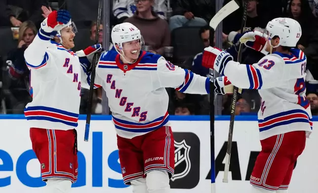 New York Rangers' Tye Kartye, left, celebrates after his goal against the Toronto Maple Leafs with Pavel Dorofeyev (16) and Adam Fox (23) during the second period of an NHL hockey game in Toronto, Thursday, Oct. 22, 2026. (Frank Gunn/The Canadian Press via AP)