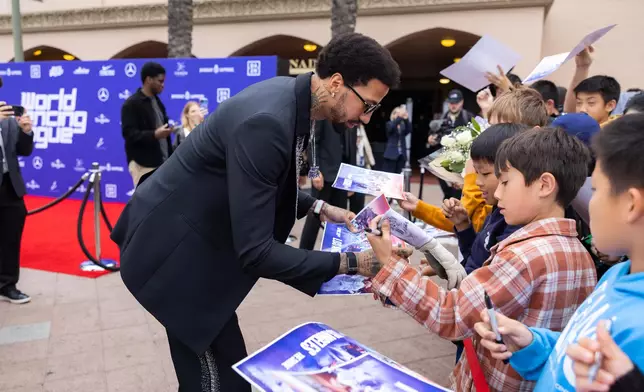 Miles Charley-Watson signs autographs with young fans at the inaugural World Fencing League in Los Angeles. Photo source: WFL