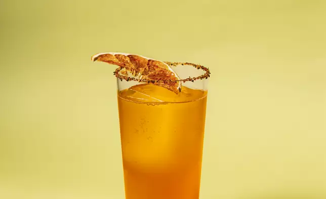 Passion Paloma: A bright, refreshing highball of Altos Plata blanco tequila, Chinola passion fruit, lime juice and agave nectar, topped with grapefruit soda and finished with a Tajín rim and dried grapefruit.