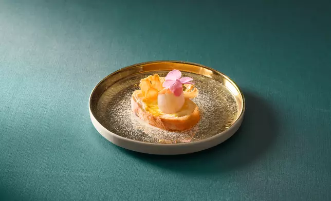 Tsui Hang Village's Pan Fried Scallops with Egg Yolk on Toast: Golden crispy toast is topped with a sweet, succulent jumbo scallop and finished with rich, creamy egg yolk mayonnaise. The contrast of textures, from crisp and crunchy to tender and delicate, creates an elegant appetiser that makes an excellent start to any banquet.