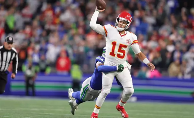 Kansas City Chiefs quarterback Patrick Mahomes (15) is hit by Seattle Seahawks safety Nick Emmanwori as he throws during the first half of an NFL football game in Seattle, Sunday, Oct. 25, 2026. (AP Photo/Kevin Ng)