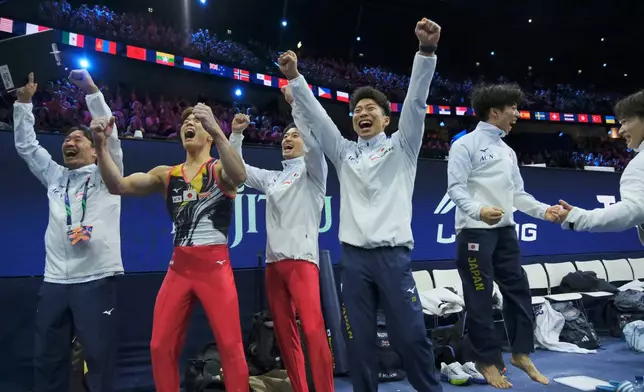 Japan athletes celebrate after winning the the men's team final at the Artistic Gymnastics World Championships in Rotterdam, the Netherlands, Tuesday, Oct. 20, 2026. (AP Photo/Patrick Post)