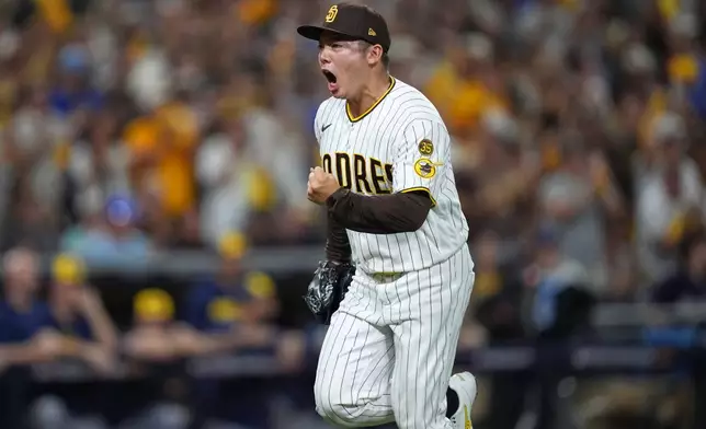 San Diego Padres pitcher Yuki Matsui celebrates after getting Milwaukee Brewers' Brice Turang to ground out with the bases loaded to end the top of the fifth inning in Game 3 of baseball's National League Division Series Tuesday, Oct. 6, 2026, in San Diego. (AP Photo/Gregory Bull)