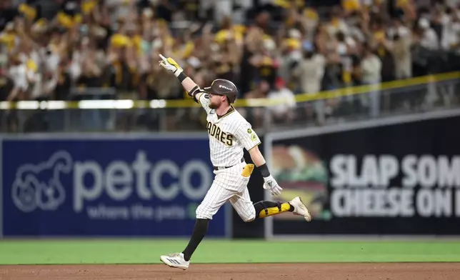 San Diego Padres' Jake Cronenworth celebrates as he rounds the bases after hitting a solo home run during the fifth inning in Game 3 of baseball's National League Division Series against the Milwaukee Brewers Tuesday, Oct. 6, 2026, in San Diego. (AP Photo/Derrick Tuskan)
