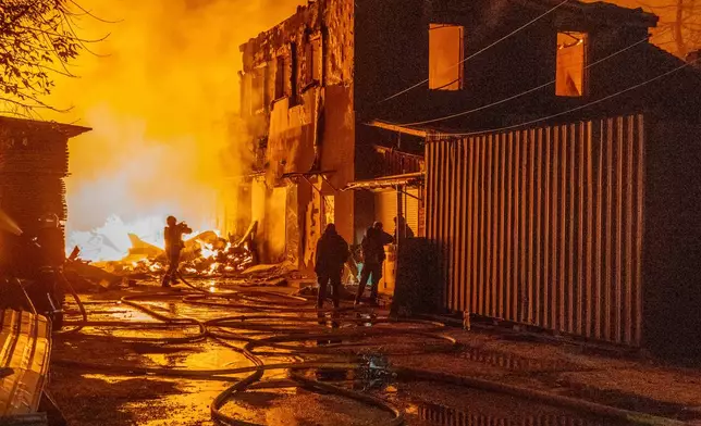 Firefighters put out a fire in a residential neighbourhood following Russia's air attack in Kharkiv, Ukraine, Wednesday, Oct. 28, 2026. (AP Photo/Andrii Marienko)