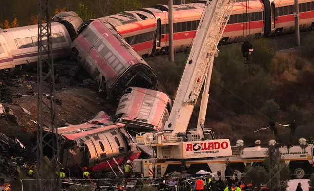 Emergency services work at the scene of a collision between two trains in Urda, Spain, on Wednesday, Oct. 28, 2026. (AP Photo/Manu Fernandez)