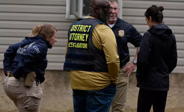 Authorities investigate the scene of a mass shooting where at least two people died and 35 were injured when struck by bullets Sunday morning, according to the Georgia Bureau of Investigation, Sunday, Oct. 4, 2026, in Vienna, Ga. (AP Photo/Mike Stewart)