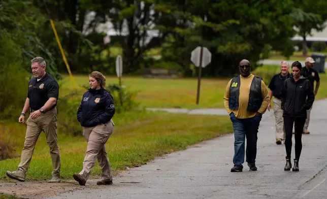 Authorities investigate the scene of a mass shooting where at least two people died and 35 were injured when struck by bullets Sunday morning, according to the Georgia Bureau of Investigation, Sunday, Oct. 4, 2026, in Vienna, Ga. (AP Photo/Mike Stewart)