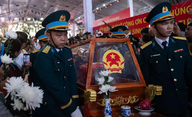 Military personnel carry the remains of 731 martyrs' remains found at Le Thi Rieng Cultural Park for burial at Ho Chi Minh City Martyrs' Cemetery Wednesday, Oct. 14, 2026, in Ho Chi Minh City, Vietnam. (AP Photo/Thanh Hue)