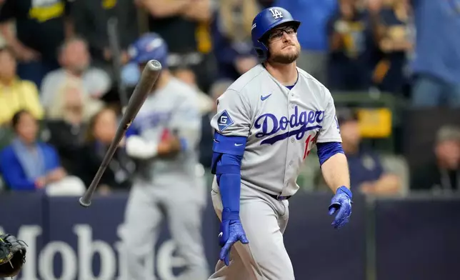 Los Angeles Dodgers third baseman Max Muncy flips his bat after popping out during the ninth inning of Game 1 of baseball's National League Championship Series between the Milwaukee Brewers and the Los Angeles Dodgers, Sunday, Oct. 11, 2026, in Milwaukee. (AP Photo/Ashley Landis)