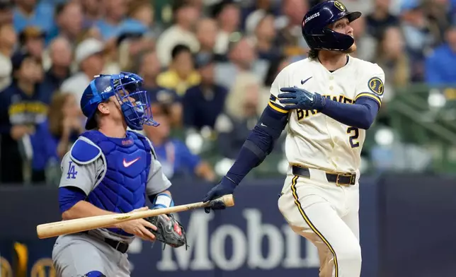 Milwaukee Brewers second baseman Brice Turang and Los Angeles Dodgers catcher Will Smith watch his solo home run take flight during the fourth inning of Game 1 of baseball's National League Championship Series between the Milwaukee Brewers and the Los Angeles Dodgers, Sunday, Oct. 11, 2026, in Milwaukee. (AP Photo/Ashley Landis)