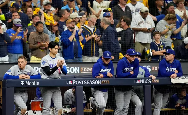 Los Angeles Dodgers players watch during the ninth inning of Game 1 of baseball's National League Championship Series between the Milwaukee Brewers and the Los Angeles Dodgers, Sunday, Oct. 11, 2026, in Milwaukee. (AP Photo/Ashley Landis)