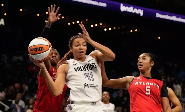 Golden State Valkyries center Kiah Stokes (41) pulls down a rebound past Atlanta Dream's Rhyne Howard, left, and Angel Reese (5) during the first half of Game 6 of the WNBA basketball finals on Thursday, Oct. 29, 2026, in Atlanta. (AP Photo/Brynn Anderson)