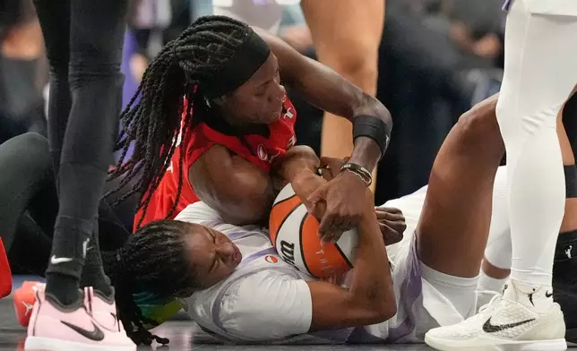 Atlanta Dream's Rhyne Howard, top, and Golden State Valkyries' Tiffany Hayes battle for the ball during the second half of Game 6 of the WNBA basketball finals on Thursday, Oct. 29, 2026, in Atlanta. (AP Photo/Brynn Anderson)