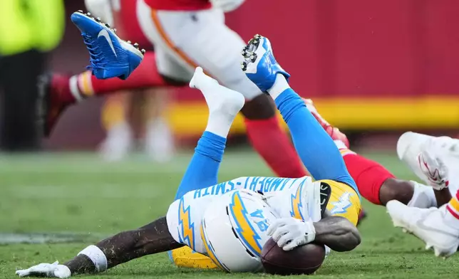 Los Angeles Chargers wide receiver Keandre Lambert-Smith (84) loses his cleat as he dives forward attempting to reach for a first down after making a catch during the second half of an NFL football game against the Kansas City Chiefs in Kansas City, Mo., Sunday, Oct. 18, 2026. (AP Photo/Charlie Riedel)