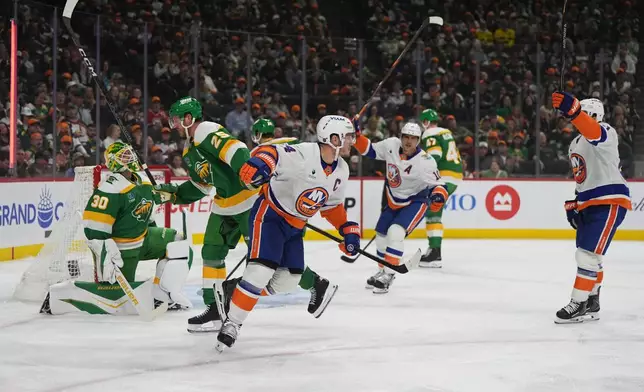 New York Islanders center Bo Horvat, middle, reacts after scoring a goal during the second period of an NHL hockey game against the Minnesota Wild, Thursday, Oct. 29, 2026, in St. Paul, Minn. (AP Photo/Abbie Parr)