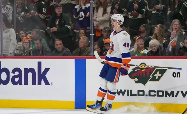 New York Islanders defenseman Matthew Schaefer (48) celebrates after scoring the winning goal during overtime of an NHL hockey game against the Minnesota Wild, Thursday, Oct. 29, 2026, in St. Paul, Minn. (AP Photo/Abbie Parr)
