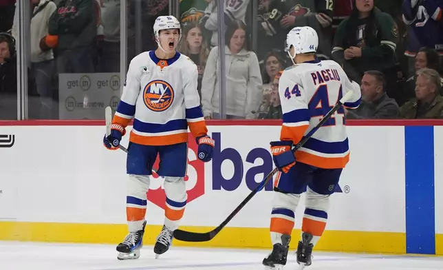 New York Islanders defenseman Matthew Schaefer, left, celebrates next to center Jean-Gabriel Pageau (44) after scoring the winning goal during overtime of an NHL hockey game against the Minnesota Wild, Thursday, Oct. 29, 2026, in St. Paul, Minn. (AP Photo/Abbie Parr)