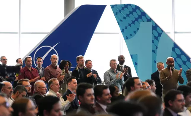 People clap for a speaker during an event celebrating the announcement of the certification of Boeing's 737 Max 10 aircraft Tuesday, Oct. 20, 2026, at Boeing's factory in Everett, Wash. (AP Photo/Lindsey Wasson)