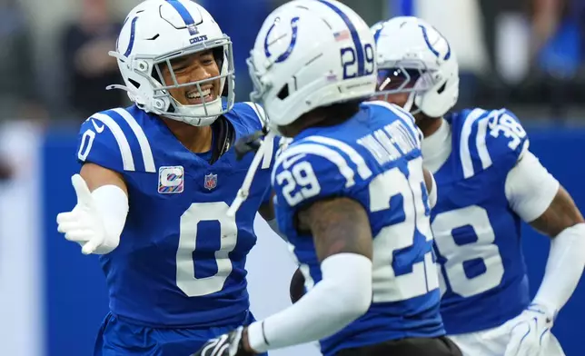 Indianapolis Colts safety Cam Bynum (0) celebrates his interception with cornerback Cam Taylor-Britt (29) and safety Jonathan Owens (38) during the first half of an NFL football game against the Tennessee Titans, Sunday, Oct. 18, 2026, in Indianapolis. (AP Photo/AJ Mast)