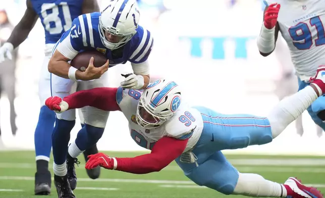 Tennessee Titans defensive tackle Jeffery Simmons (98) sacks Indianapolis Colts quarterback Daniel Jones (17) during the first half of an NFL football game Sunday, Oct. 18, 2026, in Indianapolis. (AP Photo/Jeff Roberson)