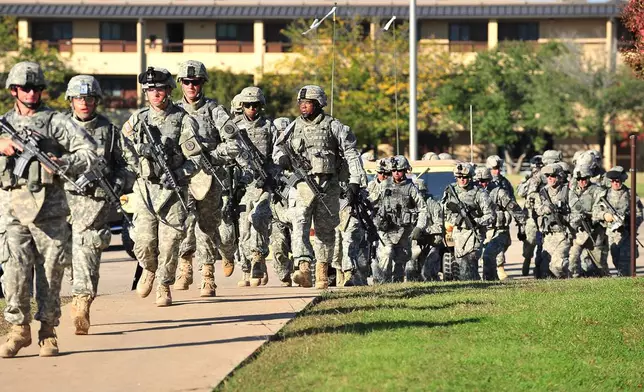 FILE - Soldiers from the 3rd Armored Cavalry Regiment storm the grounds of the Soldier Readiness Center to apprehend a mass shooter in Fort Hood, Texas, on Nov. 5, 2009. (David Morris/Killeen Daily Herald via AP, File)