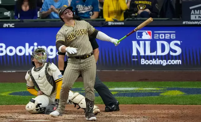 San Diego Padres' Ty France watches his ball hit a cable near the roof of American Family Field during the ninth inning of Game 1 of a National League Divisional baseball playoff series Sunday, Oct. 4, 2026, in Milwaukee. (AP Photo/Chris Carlson)
