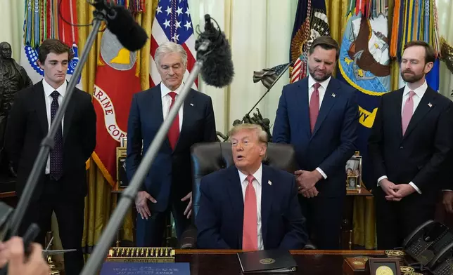 President Donald Trump speaks in the Oval Office of the White House, Tuesday, Oct. 20, 2026, in Washington, as Nick Shirley, from left, Centers for Medicare & Medicaid Services administrator Dr. Mehmet Oz, Vice President JD Vance and Andrew Ferguson, chairman of the Federal Trade Commission, listen. (AP Photo/Jacquelyn Martin)
