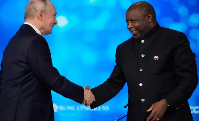 Russian President Vladimir Putin, left, and Burundi's President Evariste Ndayishimiye shake hands during the plenary session of the Russia-Africa Summit in Moscow, Wednesday, Oct. 28, 2026. (AP Photo/Pavel Bednyakov)