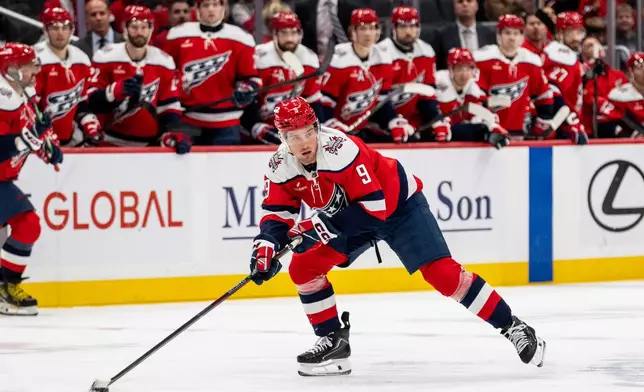 Washington Capitals right wing Ryan Leonard (9) skates with the puck during the first period of an NHL hockey game against New Jersey Devils, Saturday, Oct. 17, 2026, in Washington. (AP Photo/Nathan Howard)