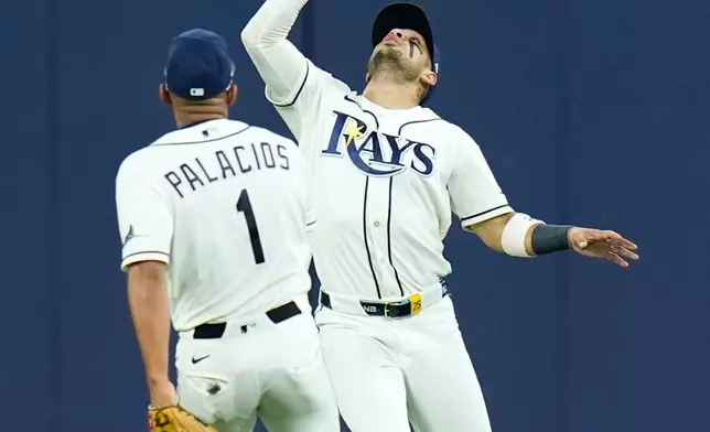 Tampa Bay Rays right fielder Victor Mesa Jr., right, catches a fly ball hit by New York Yankees' Spencer Jones that hit the ceiling of Tropicana Field for an out as Rays second baseman Richie Palacios (1) watches during the second inning in Game 2 of an American League Division Series baseball game Monday, Oct. 5, 2026, in St. Petersburg, Fla. (AP Photo/Chris O'Meara)