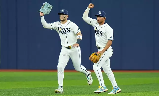 Tampa Bay Rays right fielder Victor Mesa Jr., left, and Rays second baseman Richie Palacios, right, react after Mesa Jr. caught a fly ball hit by New York Yankees' Spencer Jones that hit the ceiling of Tropicana Field for an out during the second inning in Game 2 of an American League Division Series baseball game Monday, Oct. 5, 2026, in St. Petersburg, Fla. (AP Photo/Chris O'Meara)