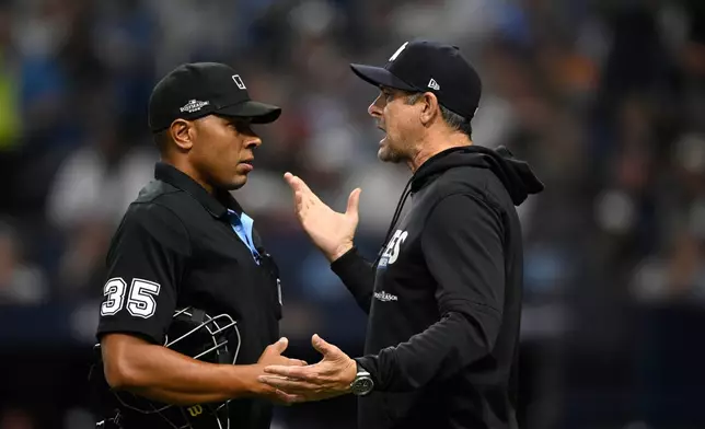 New York Yankees manager Aaron Boone, right, talks with home plate umpire Jeremie Rehak (35) after Yankees' Spencer Jones was called out on a fly ball that hit the ceiling of Tropicana Field during the second inning in Game 2 of an American League Division Series baseball game against the Tampa Bay Rays Monday, Oct. 5, 2026, in St. Petersburg, Fla. (AP Photo/Phelan Ebenhack)