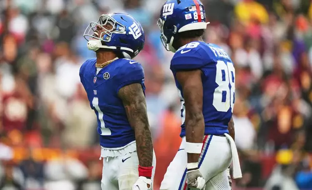 New York Giants wide receiver Malik Nabers (1) celebrates with Malachi Fields (88) after catching a pass for a touchdown during the second half of an NFL football game against the Washington Commanders in Landover, Md., Sunday, Oct. 11, 2026. (AP Photo/Stephanie Scarbrough)