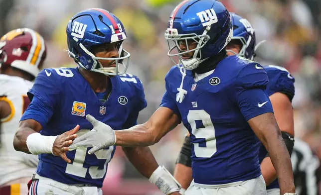 New York Giants quarterback Jameis Winston (19) celebrates with Isaiah Likely (9) after they connect for a touchdown during the second half of an NFL football game against the Washington Commanders in Landover, Md., Sunday, Oct. 11, 2026. (AP Photo/Stephanie Scarbrough)