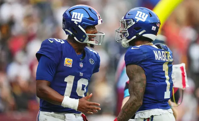 New York Giants quarterback Jameis Winston (19) celebrates with Malik Nabers (1) after they connected for a touchdown during the second half of an NFL football game against the Washington Commanders in Landover, Md., Sunday, Oct. 11, 2026. (AP Photo/Stephanie Scarbrough)