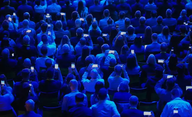 Visitors attend Nvidia CEO Jensen Huang delivering his keynote on the company's GTC event in Berlin, Germany, Wednesday, Oct. 21, 2026. (AP Photo/Markus Schreiber)