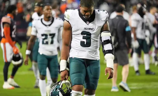 Philadelphia Eagles linebacker Nolan Smith Jr. (3), Quinyon Mitchell (27) and others walk off the field after an NFL football game against the Chicago Bears in Chicago, Monday, Sept. 28, 2026. (AP Photo/David Banks)