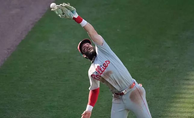 Philadelphia Phillies right fielder Bryce Harper can't catch a Atlanta Braves' Drake Baldwin fly ball in the seventh inning during Game 2 of baseball's National League Wild Card Series Wednesday, Sept. 30, 2026, in Atlanta. (AP Photo/Mike Stewart)