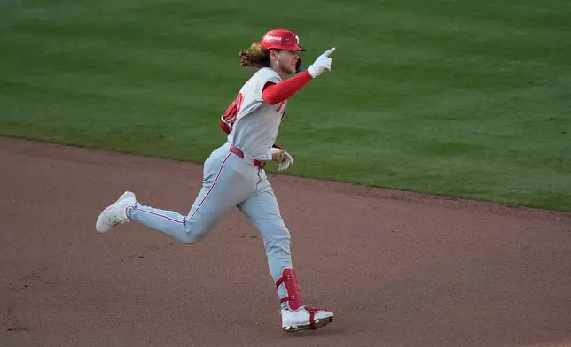 Philadelphia Phillies' Alec Bohm celebrates his home run against the Atlanta Braves in the 10th inning during Game 2 of baseball's National League Wild Card Series Wednesday, Sept. 30, 2026, in Atlanta. (AP Photo/Mike Stewart)