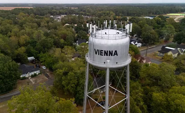 A water tower is seen as investigators work the scene of a mass shooting where at least two people died and 35 were injured when struck by bullets Sunday morning, according to the Georgia Bureau of Investigation, Sunday, Oct. 4, 2026, in Vienna, Ga. (AP Photo/Mike Stewart)