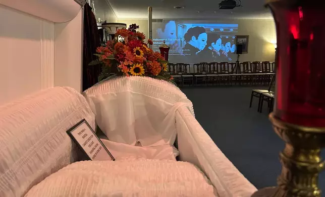 A movie is projected on the wall in the sitting room of Mortuary Manor, a former funeral home that has become a museum and host to paranormal investigations Wednesday, Sept. 30, 2026, in Toledo, Ohio (AP Photo/Mike Householder)