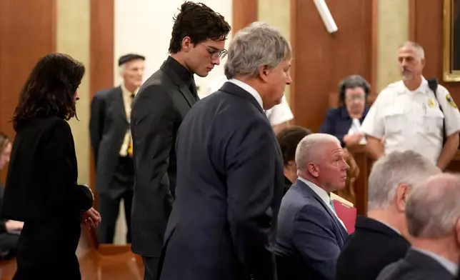 Attorneys David Meier, right, and Melinda Thompson stand with their client Braden Peters, also known as Clavicular, during his arraignment in Orleans District Court, Thursday, Oct. 22, 2026, in Orleans, Mass. (Merrily Cassidy/Cape Cod Times via AP, Pool)