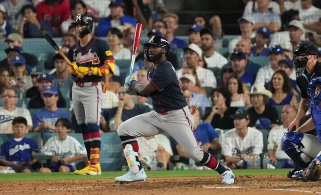 Atlanta Braves' Michael Harris II celebrates after hitting an RBI double during the seventh inning of Game 2 of a National League Division Series baseball game against the Los Angeles Dodgers Sunday, Oct. 4, 2026, in Los Angeles. (AP Photo/Jae C. Hong)