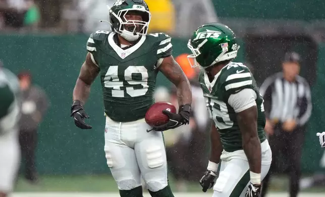 New York Jets linebacker Trevin Wallace (49) celebrates after recovering a fumble during the second half of an NFL football game against the Cleveland Browns, Sunday, Oct. 11, 2026, in East Rutherford, N.J. (AP Photo/Seth Wenig)