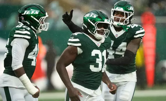 New York Jets linebacker David Bailey (31) celebrates with teammate linebacker Jamien Sherwood (44) after a sack during the second half of an NFL football game against the Cleveland Browns, Sunday, Oct. 11, 2026, in East Rutherford, N.J. (AP Photo/Seth Wenig)