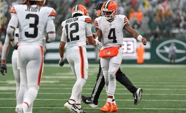 Cleveland Browns wide receiver Denzel Boston (12) celebrates with teammate quarterback Deshaun Watson (4) after catching a touchdown pass during the second half of an NFL football game against the New York Jets, Sunday, Oct. 11, 2026, in East Rutherford, N.J. (AP Photo/Yuki Iwamura)